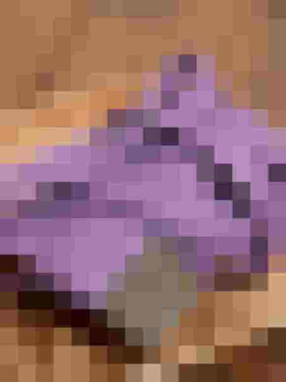 Lila Gürtel aus recyceltem Kunstleder, stilvoll auf Holzplatte drapiert.